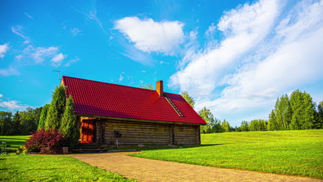 timelapse of the blue sky and a log cabin in a remote rural landscape