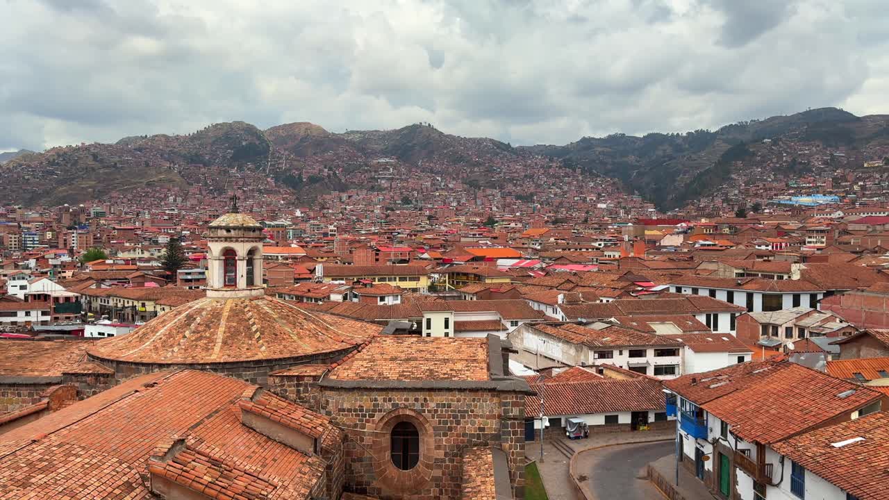 City of Cusco Cuzco Plaza de Armas Peru Perú Inca Empire capitol cityscape red roof buildings panoramic landscape Peruvian Andes rainy season sunny cloudy morning afternoon blue sky static