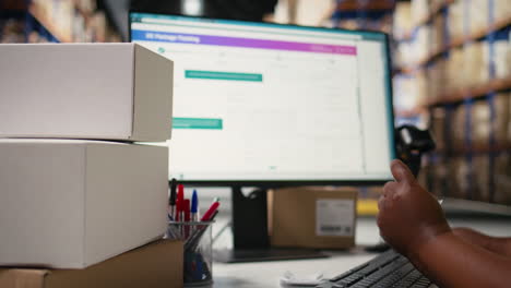 female logistics worker sticking shipping labels on cardboard boxes
