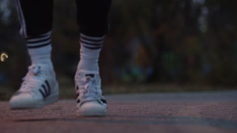 Ground level close-up of a man&#039;s feet running on a path