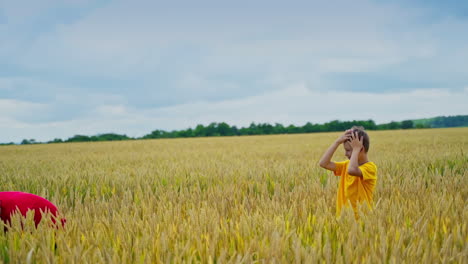 brothers having fun outdoors. boys playing with straw hat on field. children throw hat to one another on a yellow field in summer day.