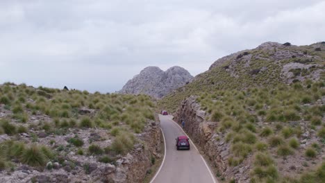 following a car drives at coll dels reis mountain pass at mallorca spain, aerial