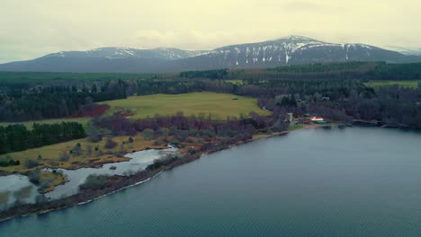 Flying-above-picturesque-Scottish-landscape-towards-a-secluded-lakeside-resort