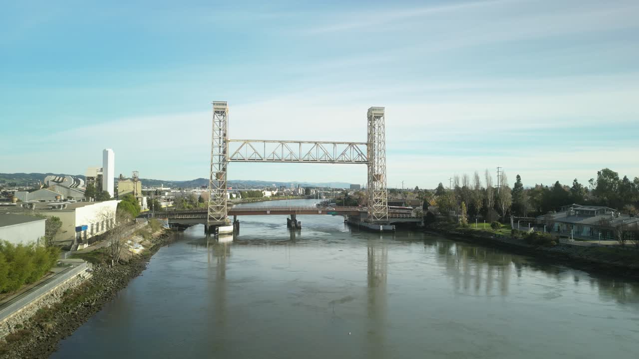 High-angle drone footage of the Miller Sweeney Bridge presents a dynamic view of this vital water crossing between Oakland and Alameda California.
