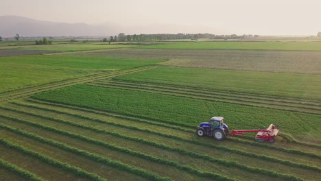 farmer drives tractor plowing field at sunset in rural farmland, 4k