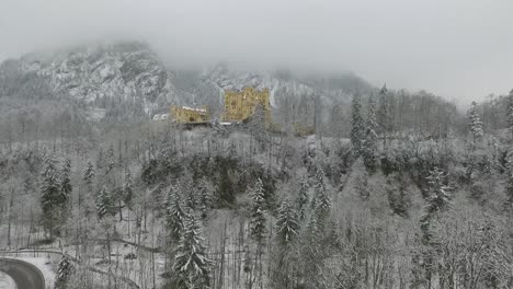 aerial view of hohenschwangau getting altitude while flying towards