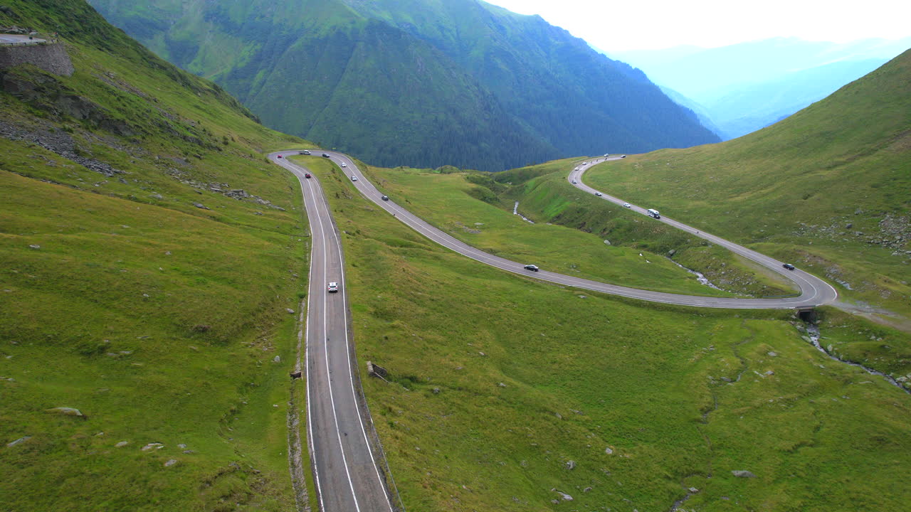 Multiple cars crossing the Romanian road of Transfagarasan. Aerial