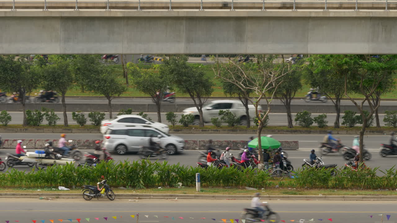 Huge flow of traffic pass roadside vendor on busy Vietnam highway