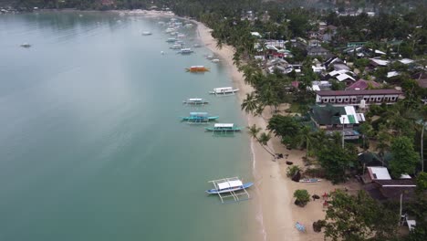 itaytay beach and port barton bay with colorful fishing boats at seaside village, philippines