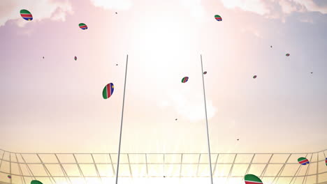 animation of rugby balls coloured with flag of namibia at stadium