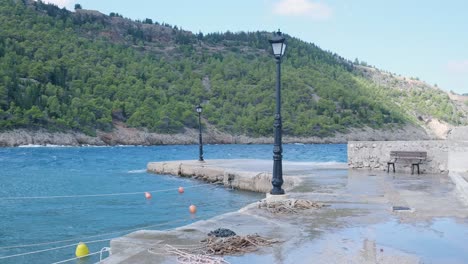 coastal pier with bench and mountains