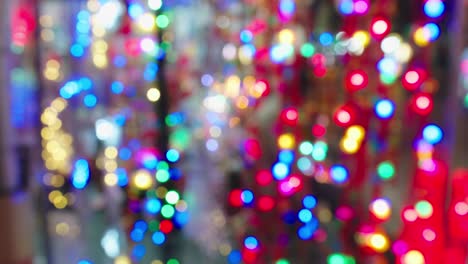 out-of-focus shot of bright led's flickering in a street market in lang son, vietnam