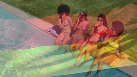 at poolside, women in swimsuits sipping drinks, chatting and relaxing together