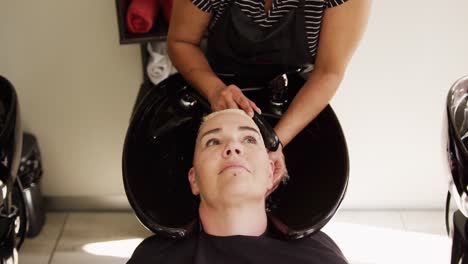 High-angle-view-woman-having-her-hair-washed