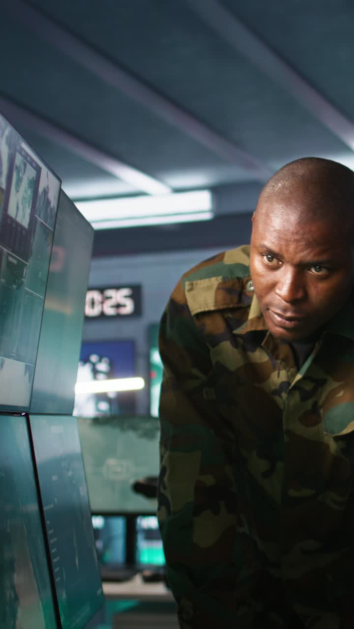 Vertical video Team of soldiers looking at screens in command center