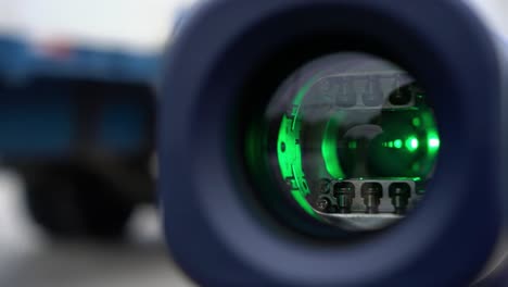 close-up view of a high-tech optical lens showcasing intricate internal components and color variations in a focused perspective for enhanced visual clarity.