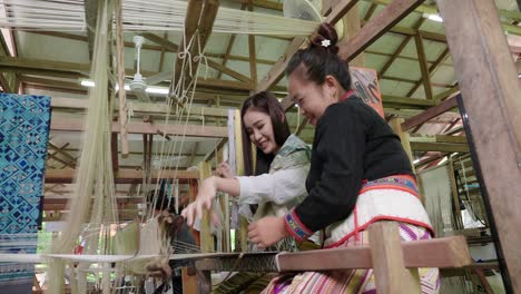 women weaving traditional thai textiles