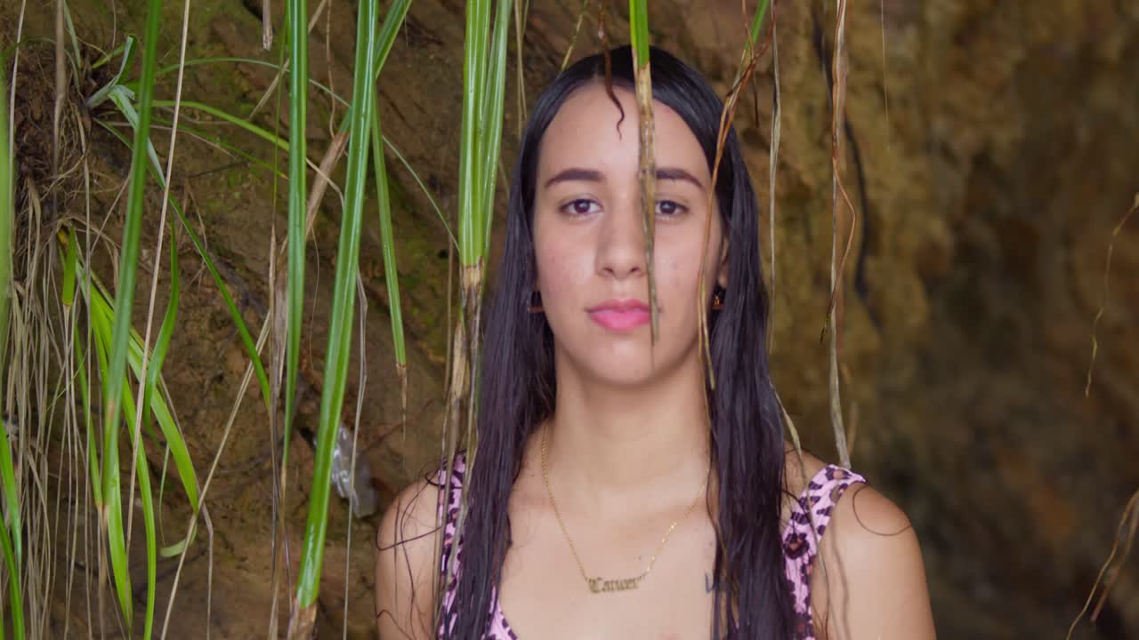 In a thong bikini, a woman's face is intimately captured, soaking in the sun and sea