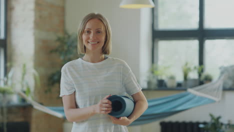 portrait of smiling woman in yoga studio