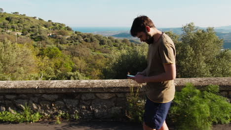 athlete relaxes while walking and chatting on his smartphone