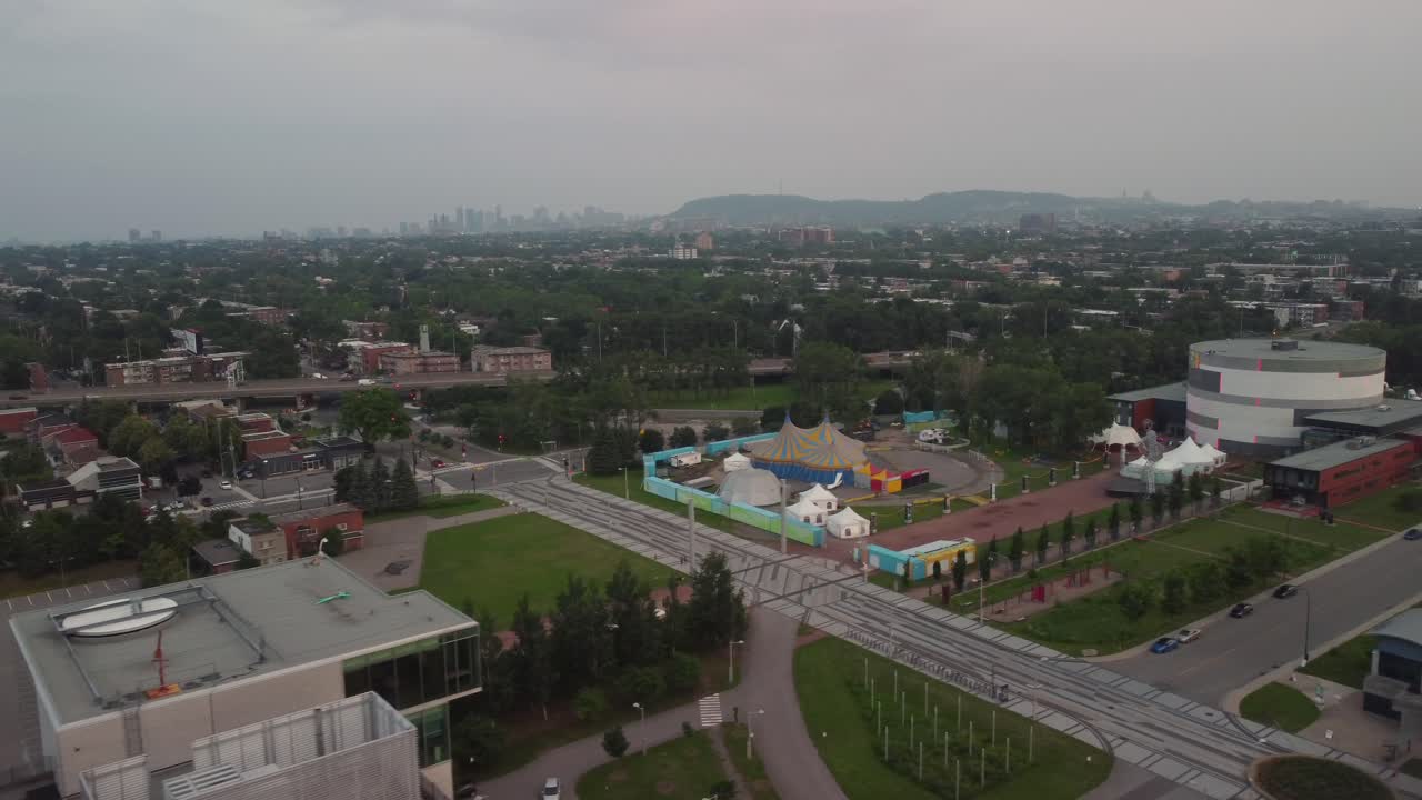 Building rooftop view to park with Montreal city skyline in distance
