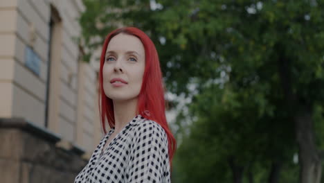 woman with red hair looking up