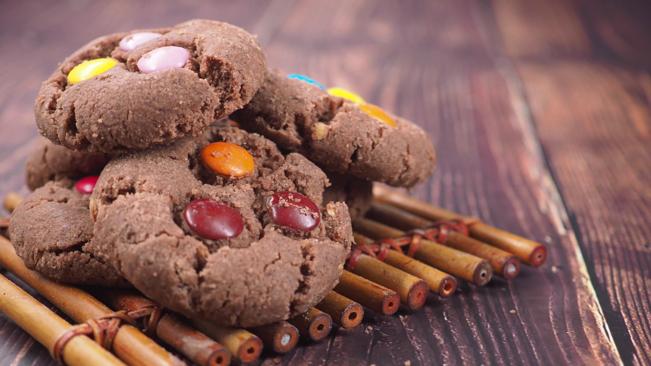 Close-up of Chocolate Cookies with Colorful Candy on a Wooden Table