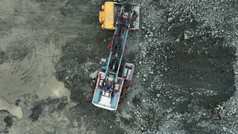 aerial view of excavators and dump trucks at a construction site