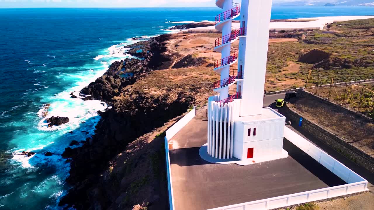 The buenavista lighthouse in tenerife, coastal landscape with clear skies, aerial view