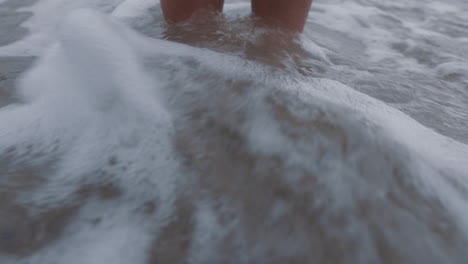 close up feet waves splashing barefoot woman standing on beach enjoying refreshing ocean seaside vacation