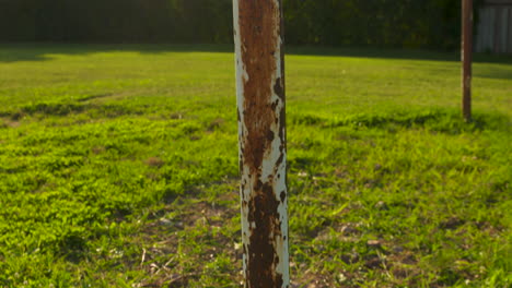 pan up along the rusted poles of an old soccer goalpost