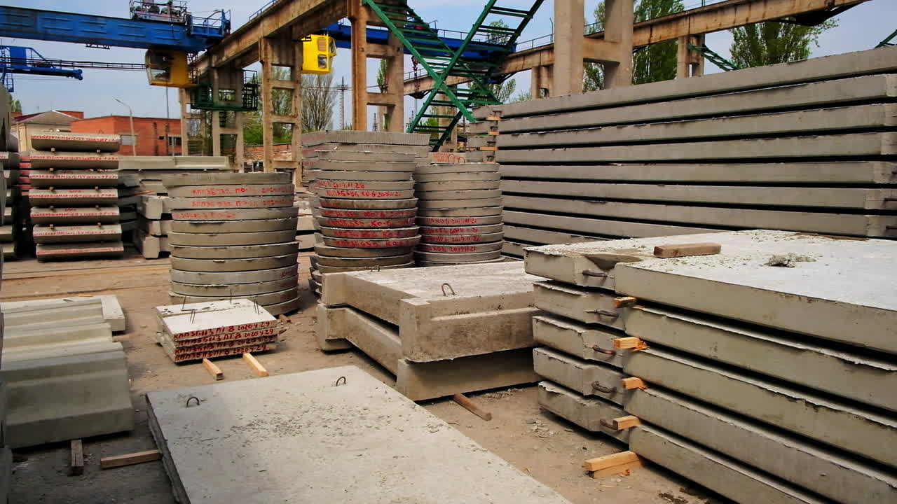 Reinforced concrete materials of diverse shape and size. Metal supports, ladders and cranes for lifting bricks and blocks.