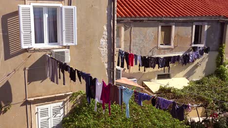 laundry hangs outside a decaying villa in europe