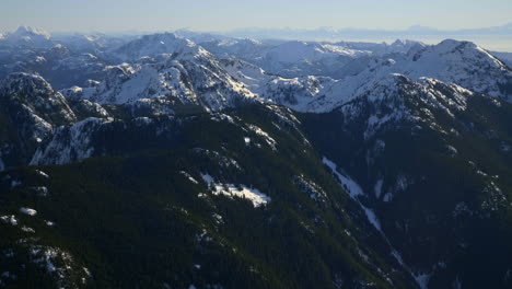 the scenic view of high snowy mountains in pemberton, british columbia, canada during daytime - aerial shot