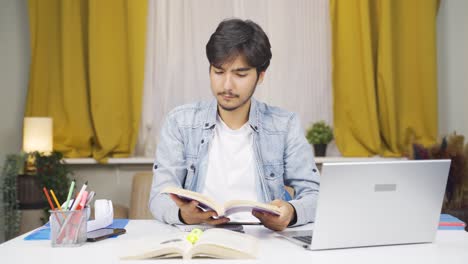 Happy-male-student-reading-a-book.