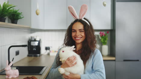 woman with a bunny during easter in the kitchen
