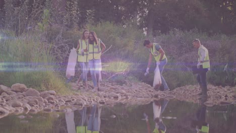 Video-of-lights-moving-over-happy-diverse-group-cleaning-up-rubbish-in-countryside