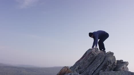 man hiking on mountain summit