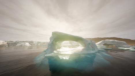 a large iceberg with a hole in the middle in the ocean