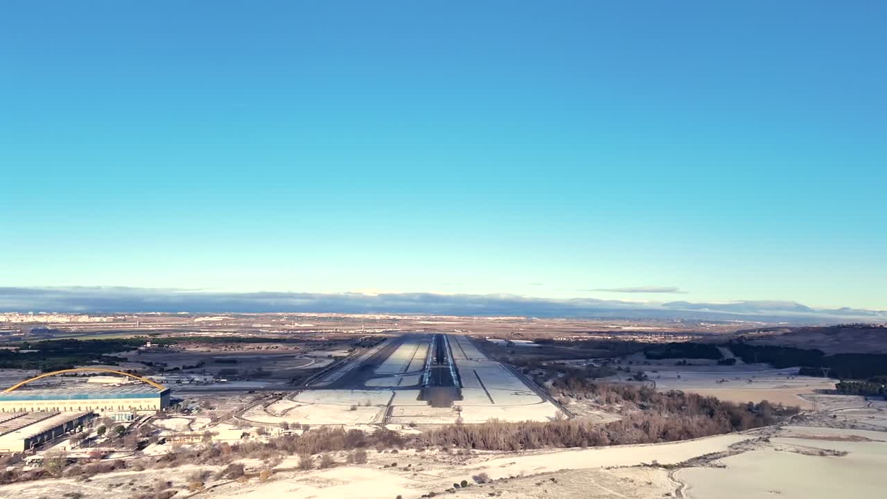 Immersive cockpit view of a fast motion shot X4 in a real approach and landing at Madrid airport runway RWY36R after a snowfall, with shadows covering partially the runway