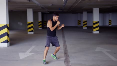 boxer does training punches in underground parking