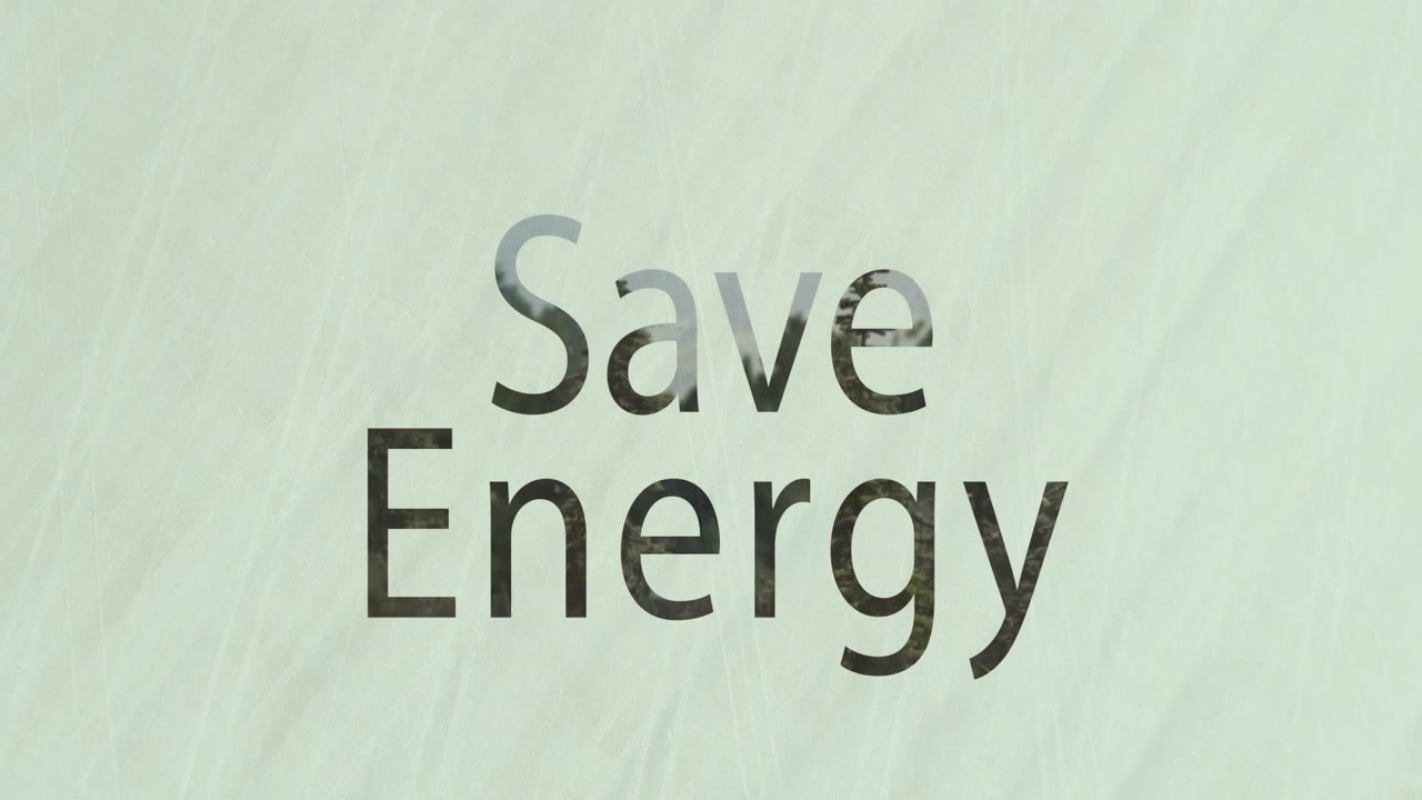 Animation of save energy and low angle view of grasses over landscape in background