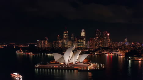 sydney opera house and city skyline at night