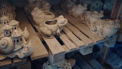 artisan inspecting decorative garden sculptures