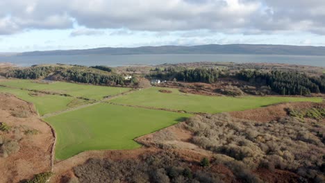 aerial - green pastures and farmland, isle of gigha, kintyre, scotland, rising
