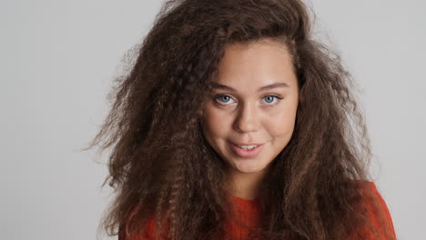 Caucasian-curly-haired-woman-smiling.