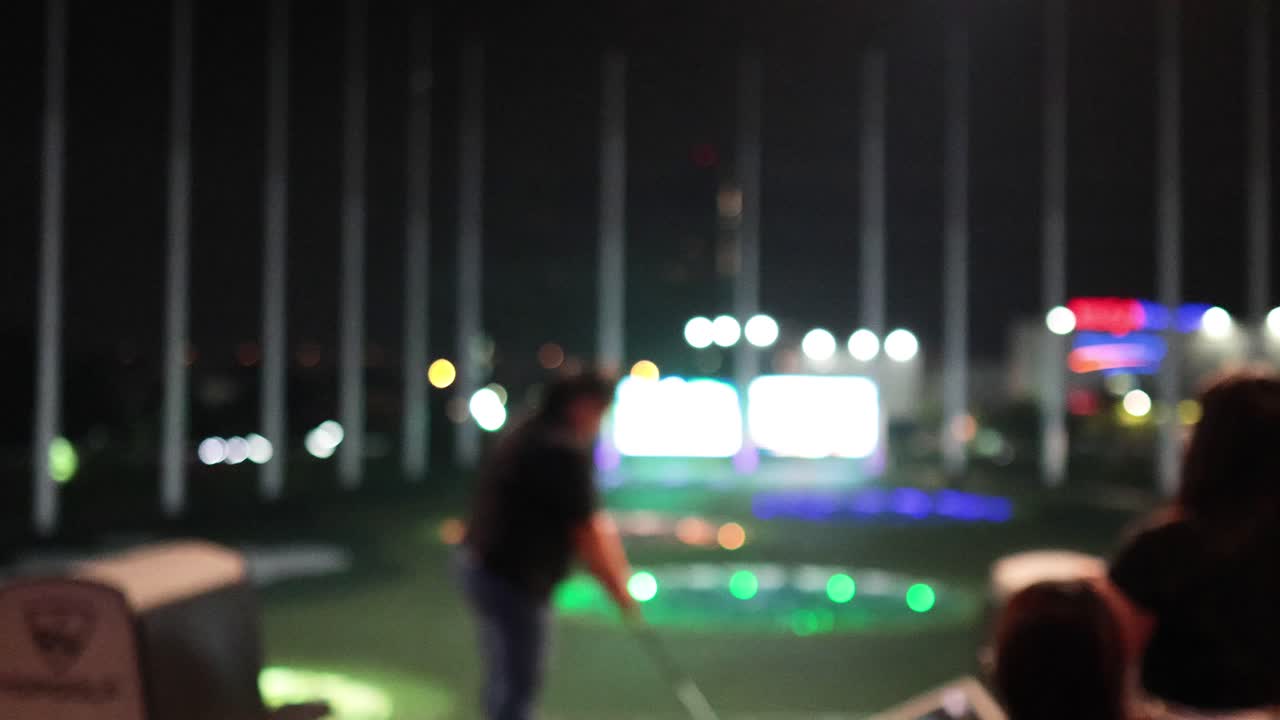 People enjoying a golf game at night