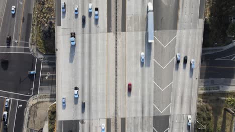 overhead drone shot capturing steady, slow traffic on a busy highway, as commuters navigate their journey home