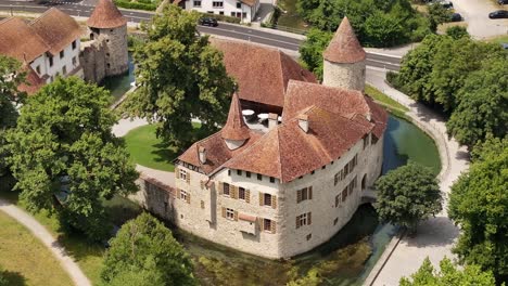 aerial view of schloss hallwyl castle surrounded by moat and trees in seengen, switzerland