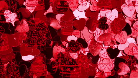 animation of christmas jumpers over glowing pink hearts